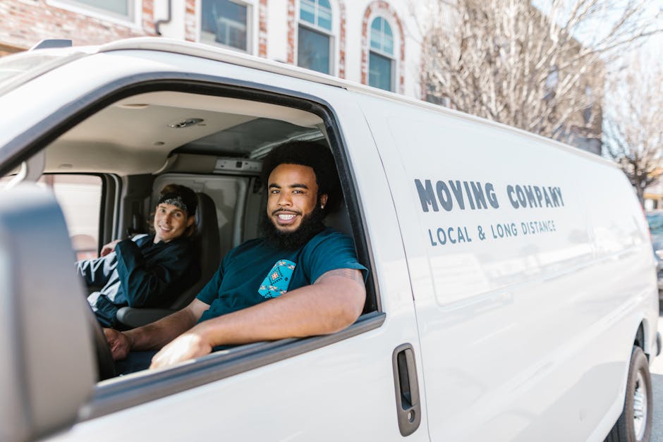 Friendly and professional movers smiling while preparing for a residential move