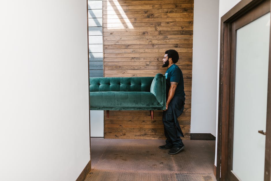 Strong movers carrying heavy furniture out of a house
