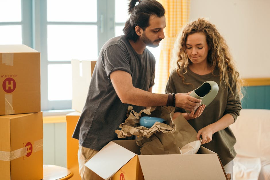 Movers unpacking boxes in a beautiful new living room